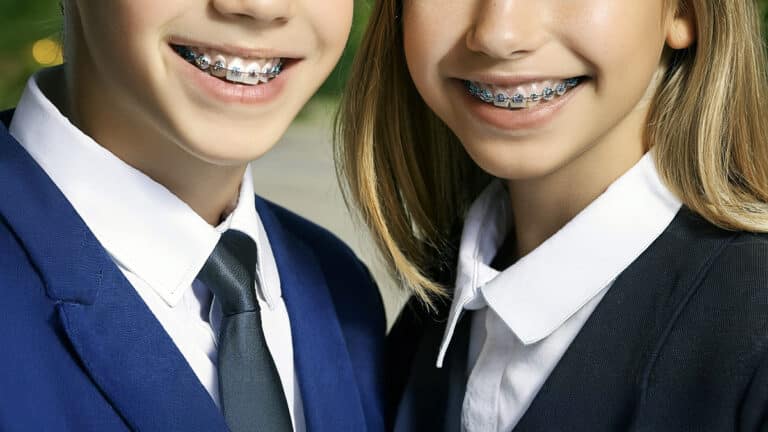 Boy and girl with braces in private school uniforms
