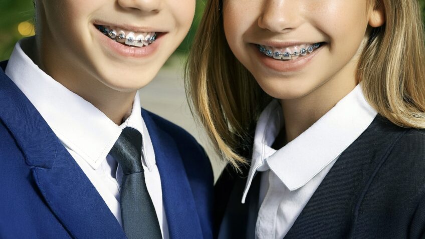 Boy and girl with braces in private school uniforms