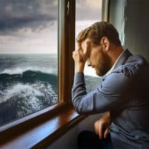 Despondent man overlooking stormy seas