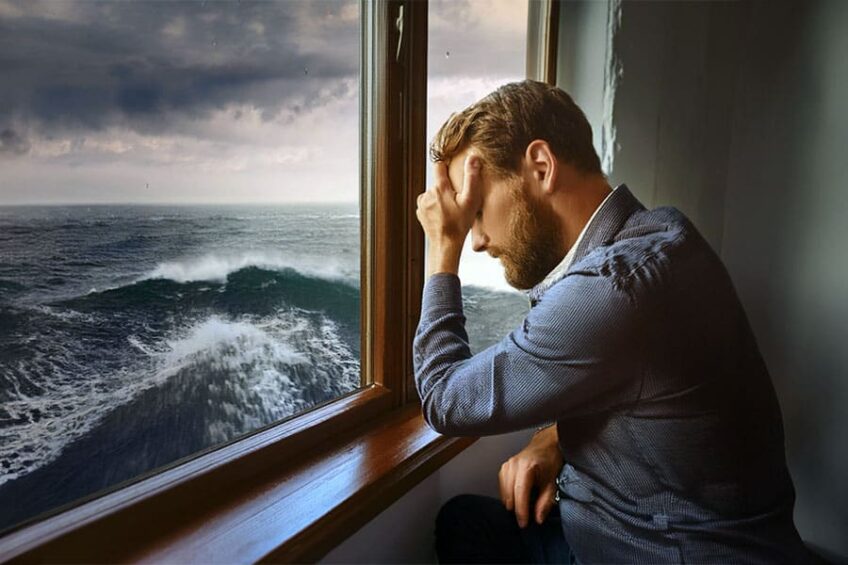 Despondent man overlooking stormy seas