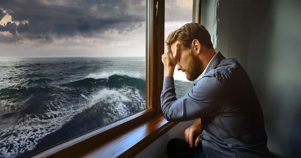 Despondent man overlooking stormy seas