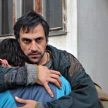 Father clutching son