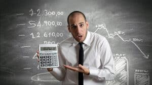 Man incredulous with calculator result