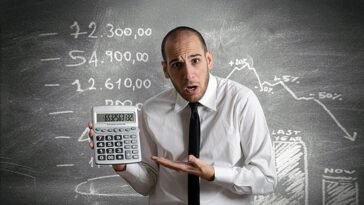 Man incredulous with calculator result