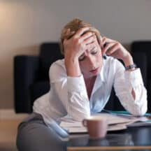 Woman holding forehead