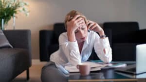 Woman holding forehead