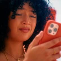 Woman on sunbed looking at her phone with interest